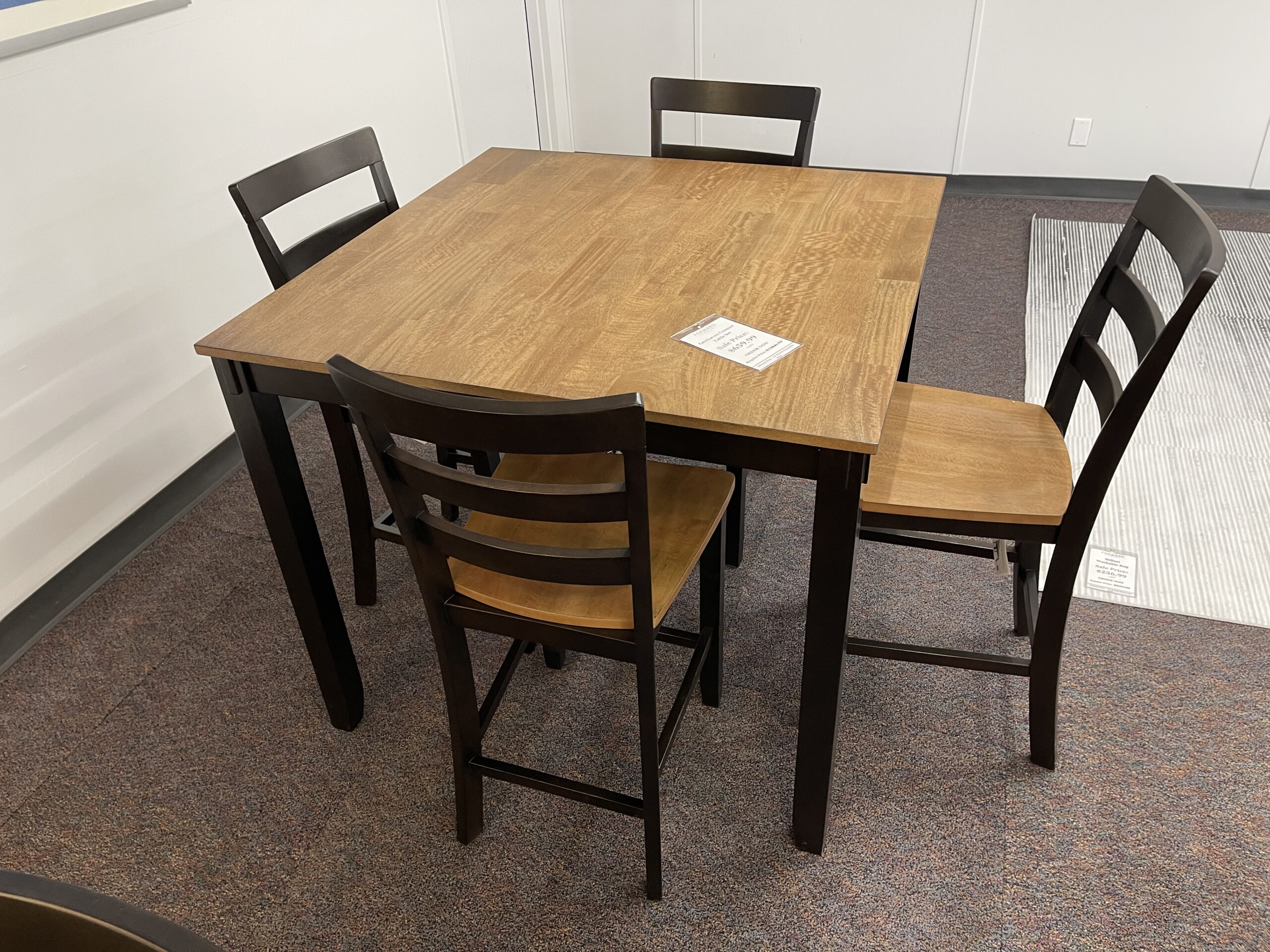 A casual Ashley Furniture Gesthaven dining table set featuring a natural wood top, contrasting painted base, bench, and matching ladderback chairs, displayed at Forward Furniture Edmonton.