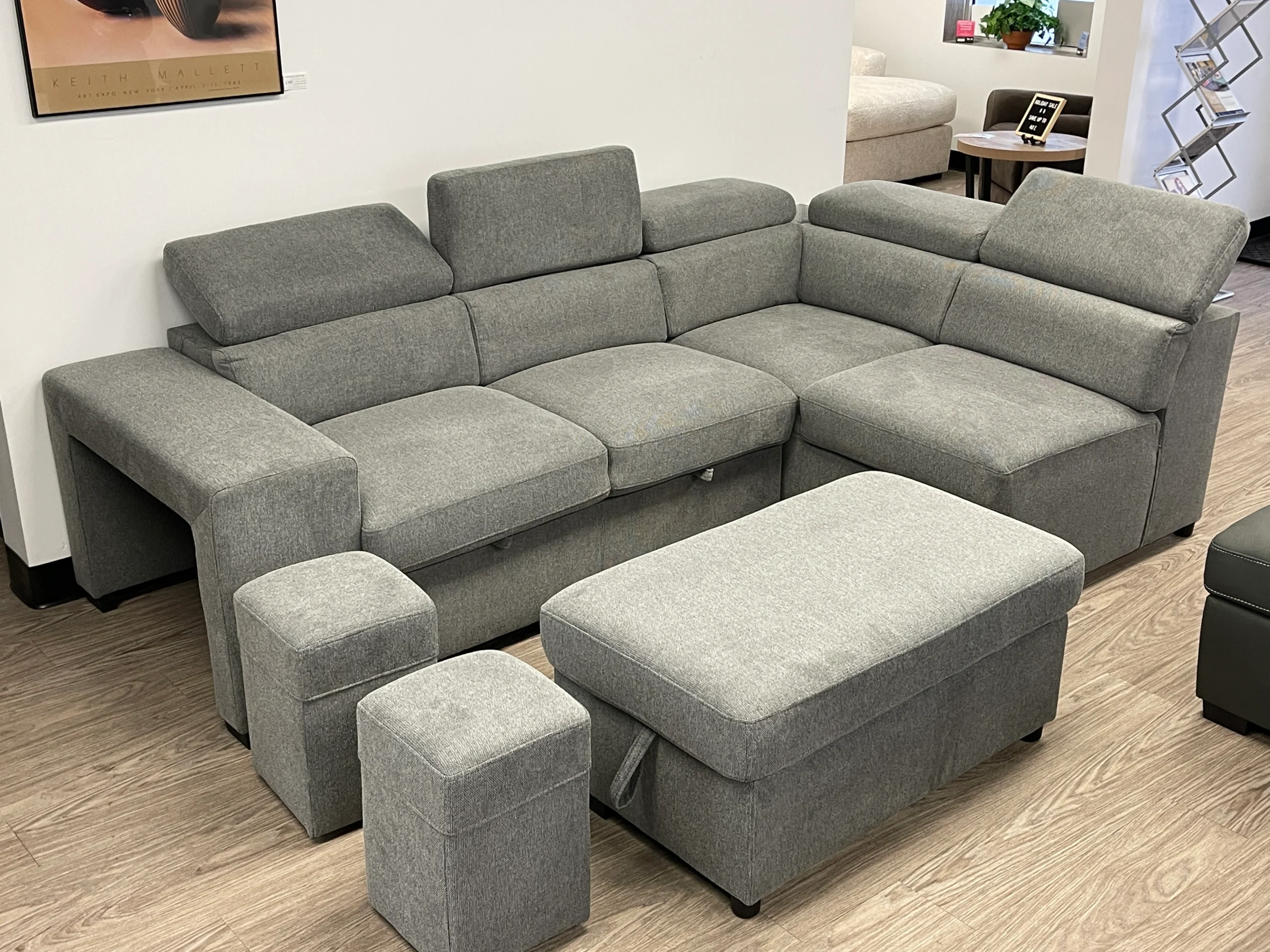 Pull out sofa bed with storage chaise, stools for the kids, multi position head rests, in the showroom West Edmonton